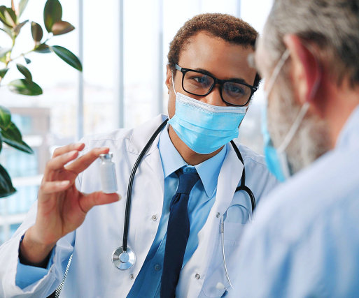 a doctor showing medicine to his patient