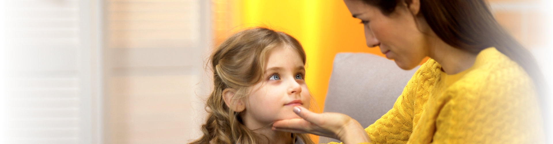 little girl is being comforted by her mother