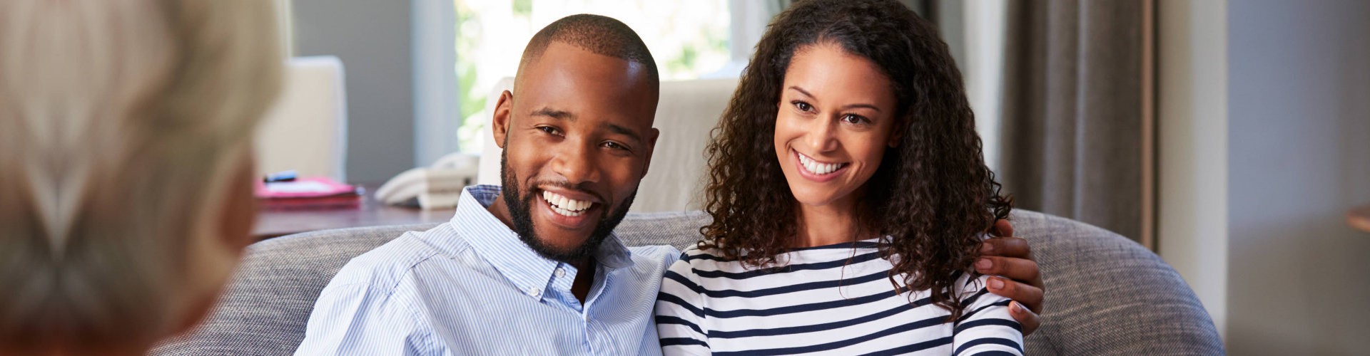 a couple smiling to their therapist