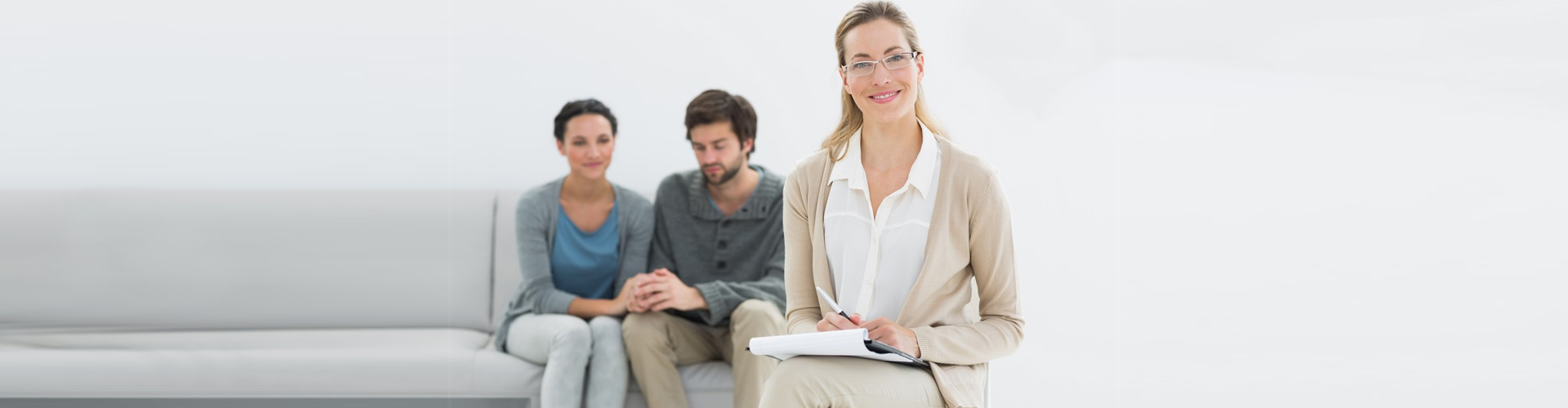 therapist smiling at the camera after her session with her clients